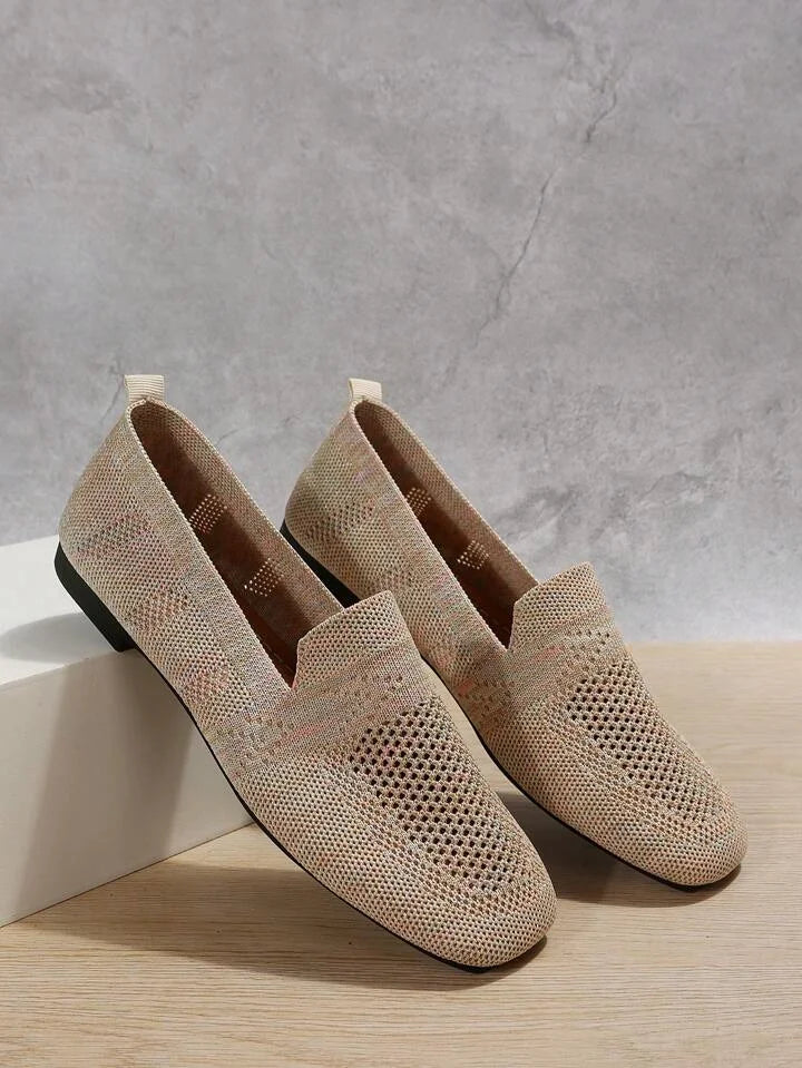 Close-up of flexible women's orthopedic ballet flats, soft material, non-slip sole, arch support.