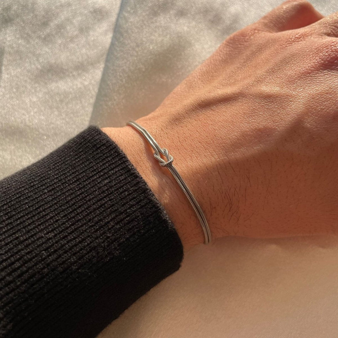Polished love knot bracelet, women's elegant and timeless fashion accessory.