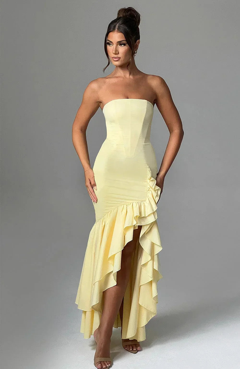 Beautiful elegant sleeveless maxi dress for women, featuring ruffles & a chic leg slit. Wedding ready.
