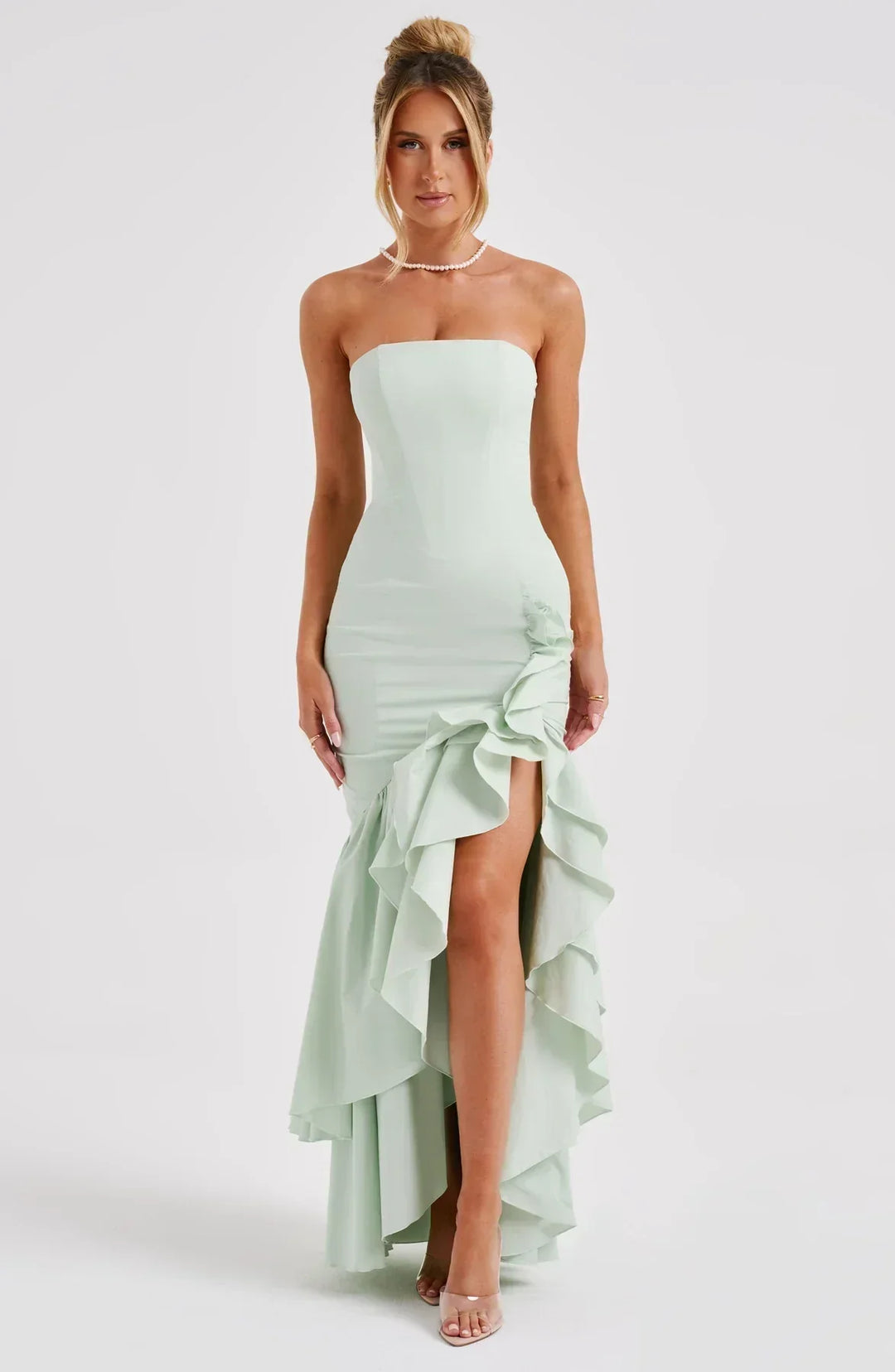 Stylish women's evening gown: sleeveless, ruffled, flowing maxi dress with a flattering slit.