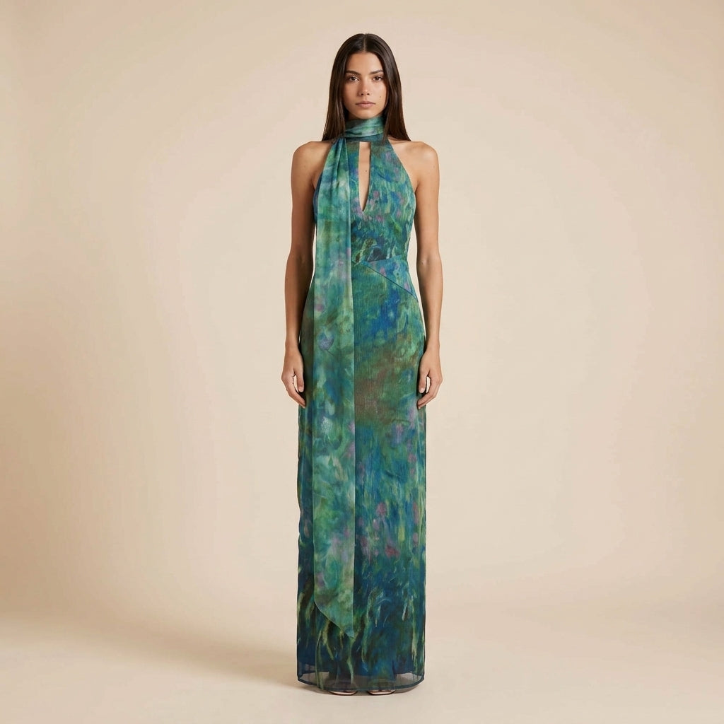 Elegant women's halter neck maxi dress with an artistic floral print, perfect for summer vacations & special occasions.