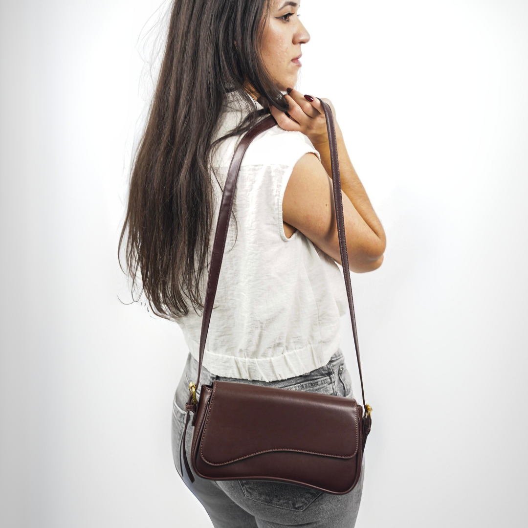 Women's elegant leather crossbody bag with adjustable strap, a timeless accessory.