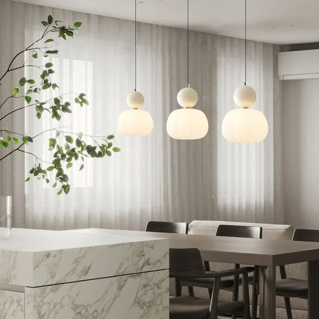 "Art Deco Cream Pendant Light with Bauhaus design, features high-quality metal frame and warm glow for elegant home lighting.