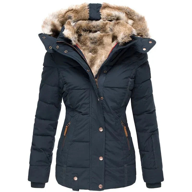 Woman posing in a stylish women's winter puffer jacket with a luxurious faux fur hood, ideal for cold weather.
