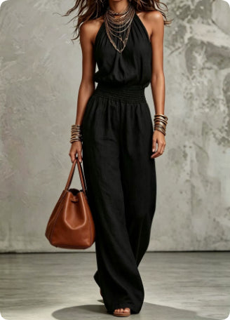 Must-have women's fashion: Halter neck wide-leg smocked waist jumpsuit for summer elegance.