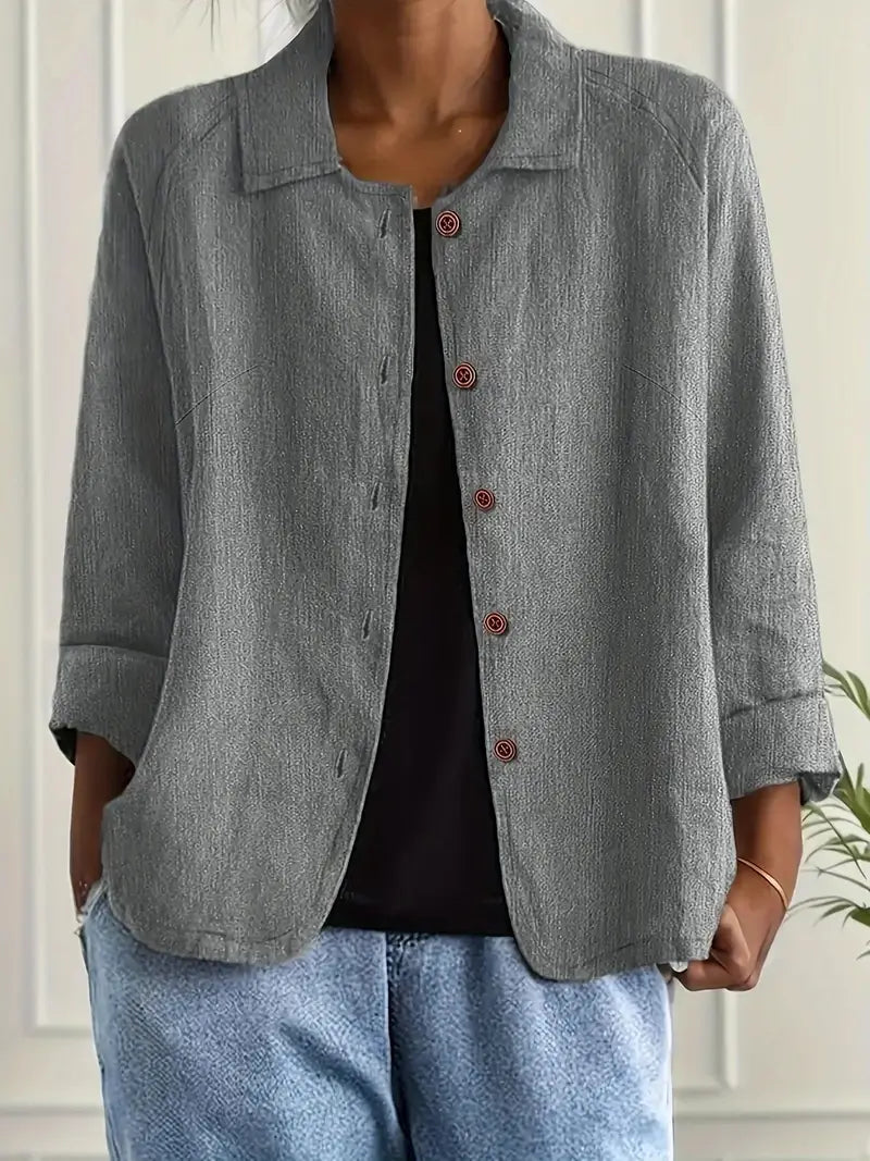 Smart women's collared button-down top, three-quarter sleeves, perfect for office or casual chic.