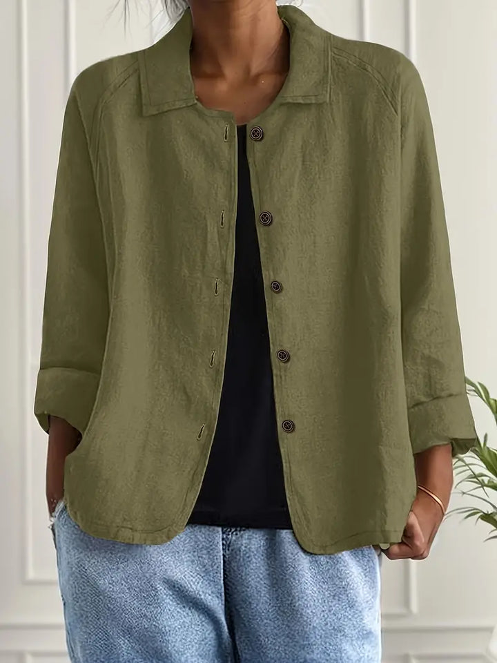 Modern women's blouse featuring a collar, button-down closure, and versatile 3/4 length sleeves.