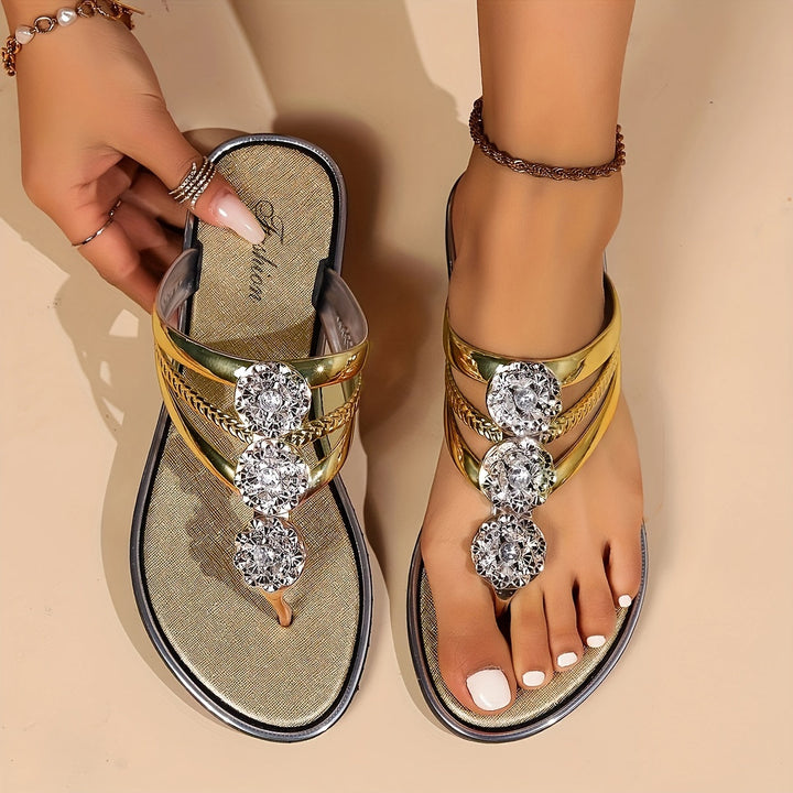 Comfortable women's T-strap flat sandals with sparkly rhinestones, perfect for everyday wear.