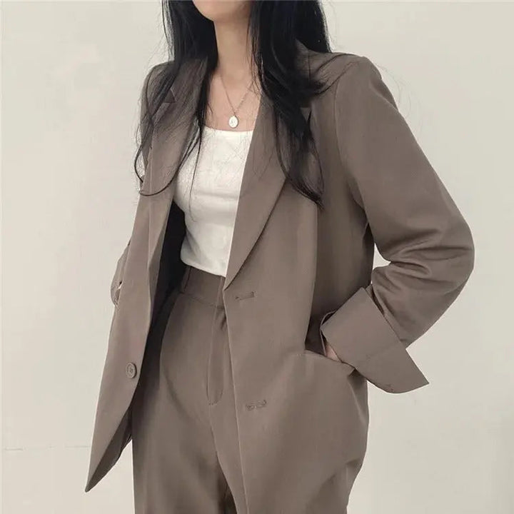 Hanger shot of women's elegant two-piece suit, ready for office or special occasions.