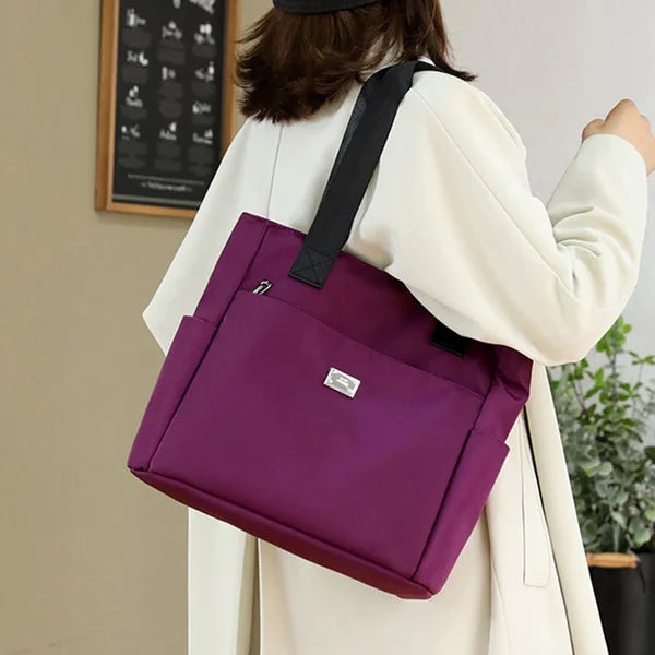 Red women's shoulder bag, lightweight & waterproof. Fashionable & practical everyday carry.