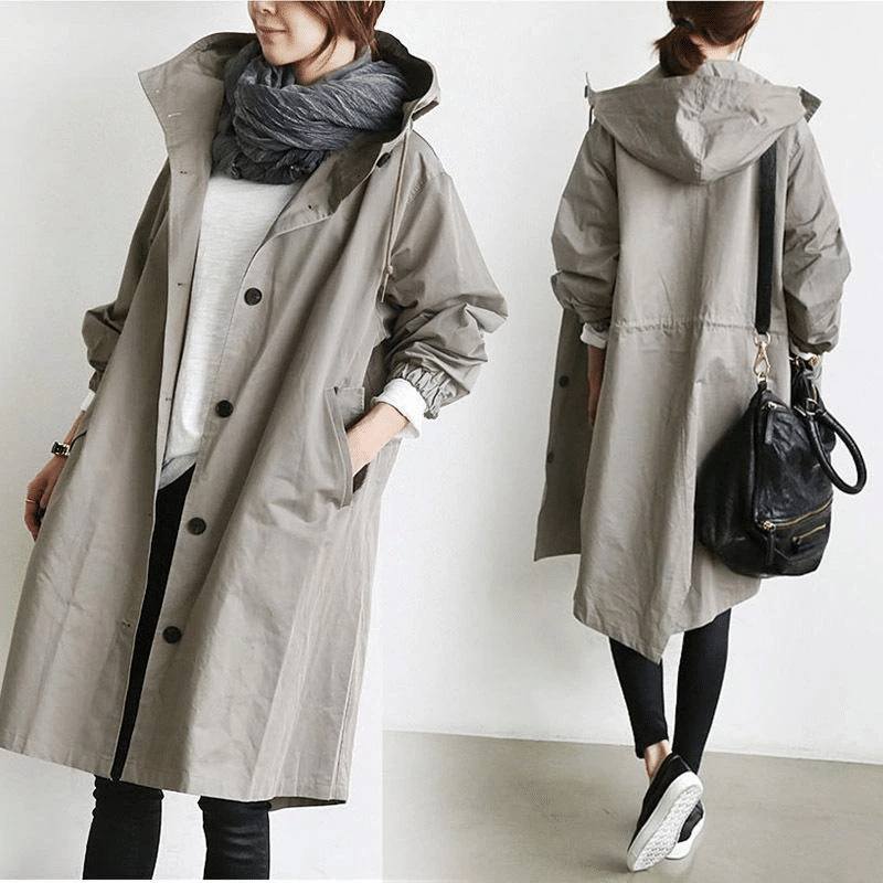 Stylish women's hooded jacket, oversized fit, offering waterproof protection for outdoor fashion.
