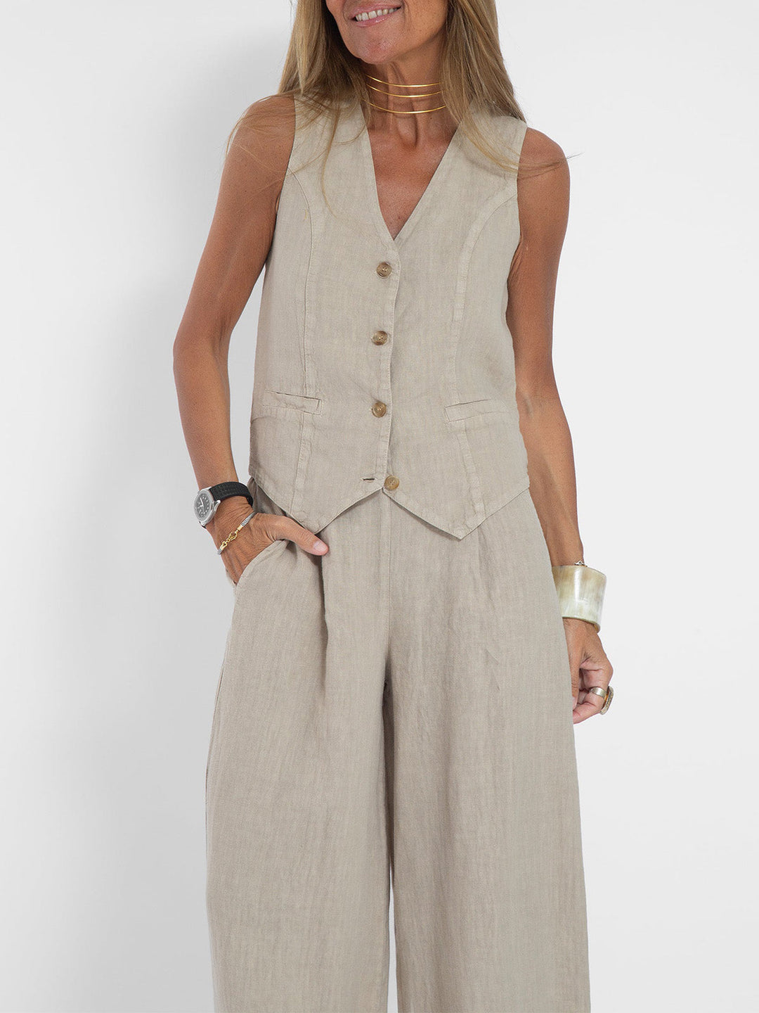 Elegant women's fashion set: sleeveless V-neck top paired with comfortable wide-leg trousers.