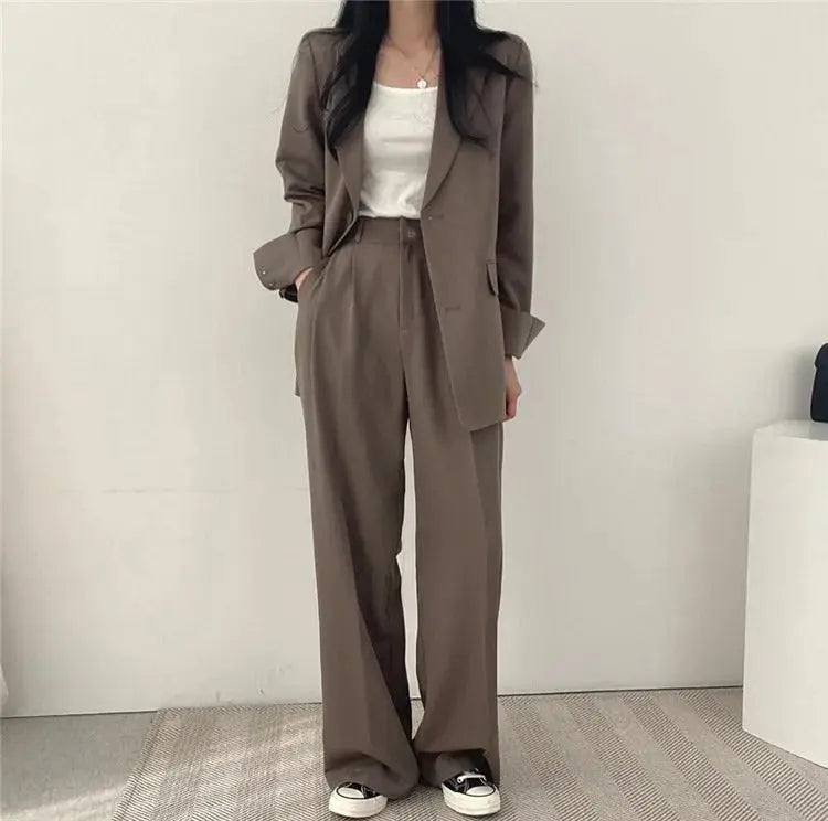 Women's sophisticated two-piece outfit, tailored blazer & trousers for a polished look.