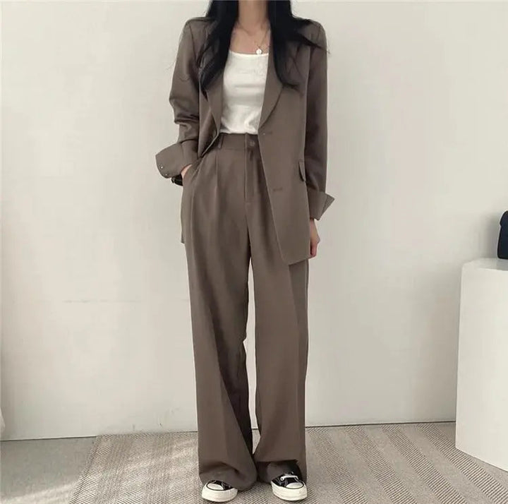 Women's sophisticated two-piece outfit, tailored blazer & trousers for a polished look.