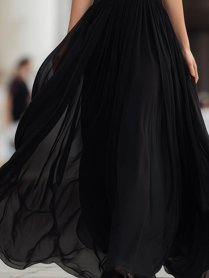 Stylish women's pleated maxi dress with a halter neck, suitable for elegant evening wear or a wedding.