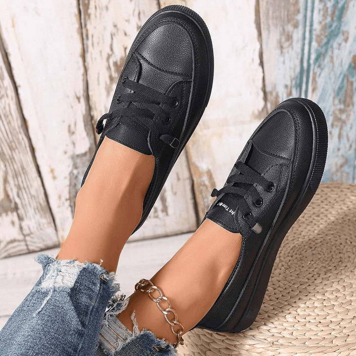 Orthopaedic white lace-up trainers for women, ensuring all-day walking comfort.