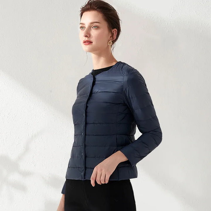 Comfortable women's lightweight puffer, designed with a collarless neck for a modern, slimming look.