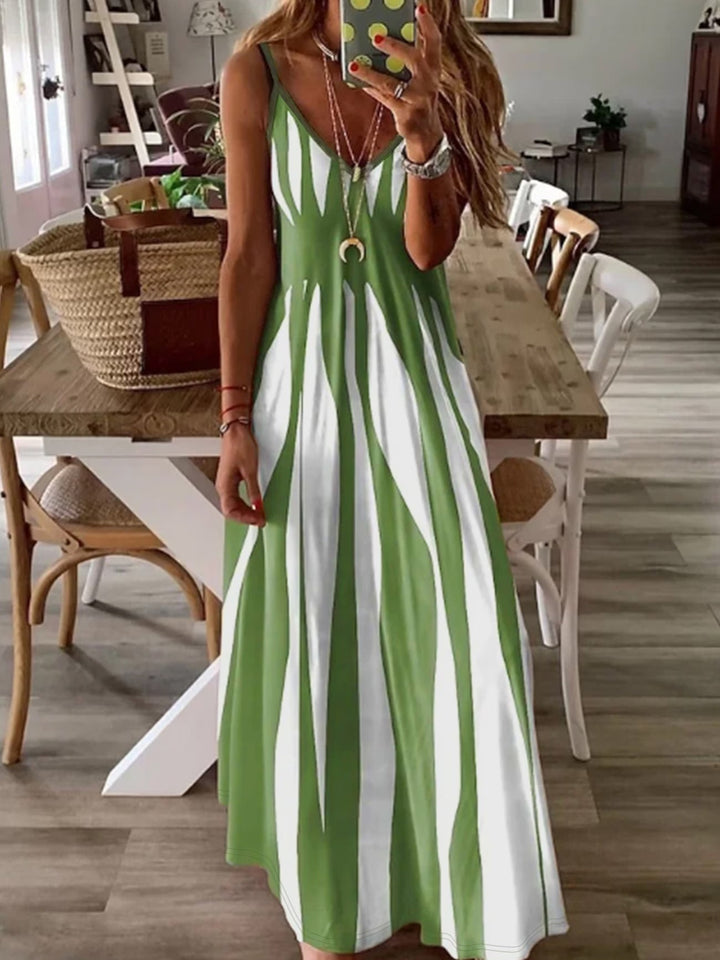 Chic green women's V-neck dress with thin spaghetti straps. Comfortable, flowing, and perfect for summer elegance.