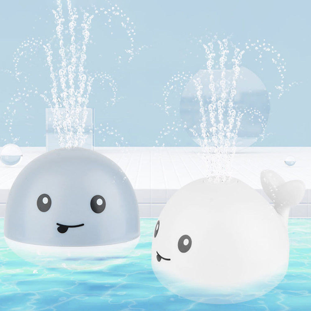 Interactive whale sprinkler bath toy, perfect for toddlers. Features LED lights for engaging water & floor play.