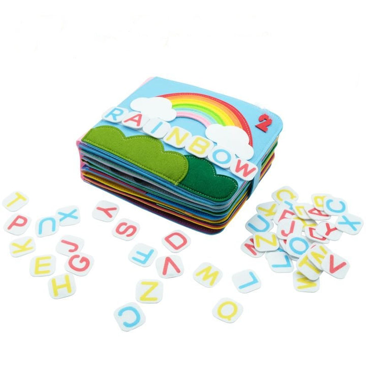 Close-up of a washable baby cloth book featuring buckles, zippers & textures for Montessori early learning sensory play.