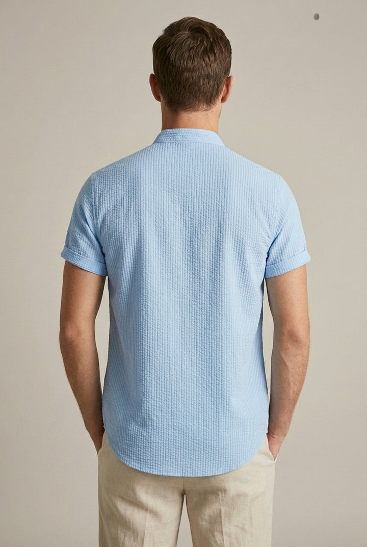 Textured fabric men's short sleeve summer shirt featuring a band collar. Stylish casual button front for summer wear.