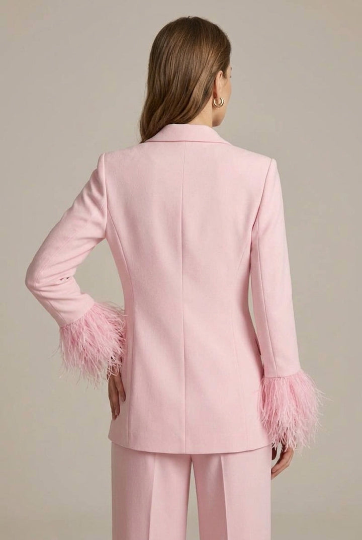 Women's tailored pink trouser suit with feather cuff blazer, straight leg pants. Sophisticated office & occasion wear.