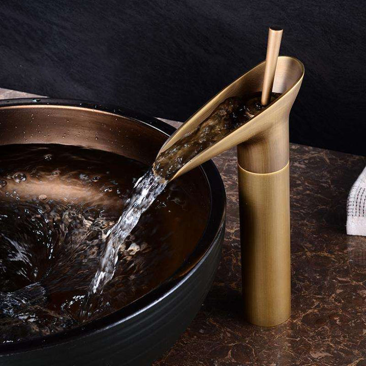 Elegant brass waterfall basin faucet, modern mixer tap for stylish bathrooms.