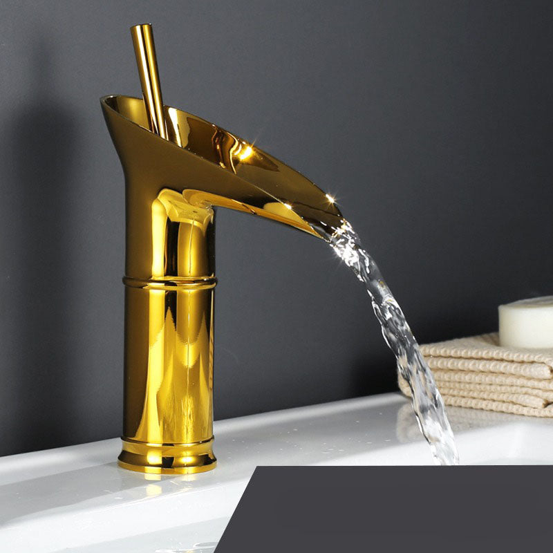 Brass waterfall bathroom faucet, a blend of modern function and elegant form.