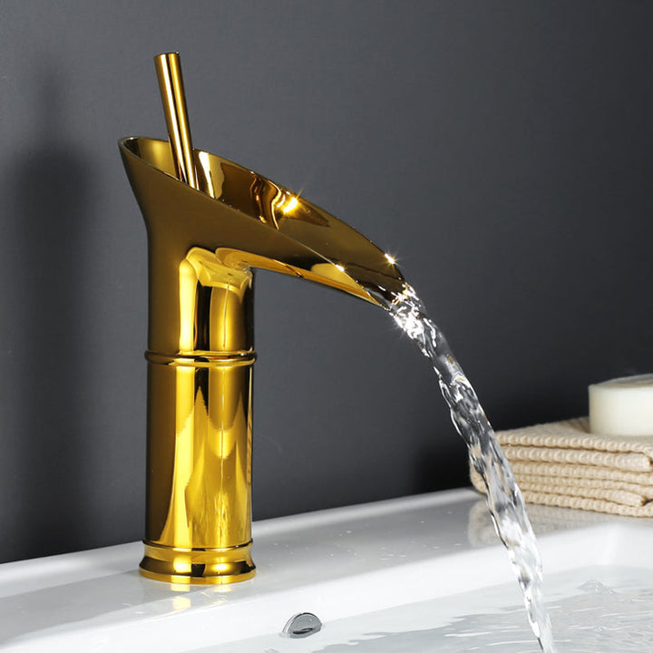 Luxury brass waterfall mixer tap, smooth finish, enhancing bathroom aesthetics.