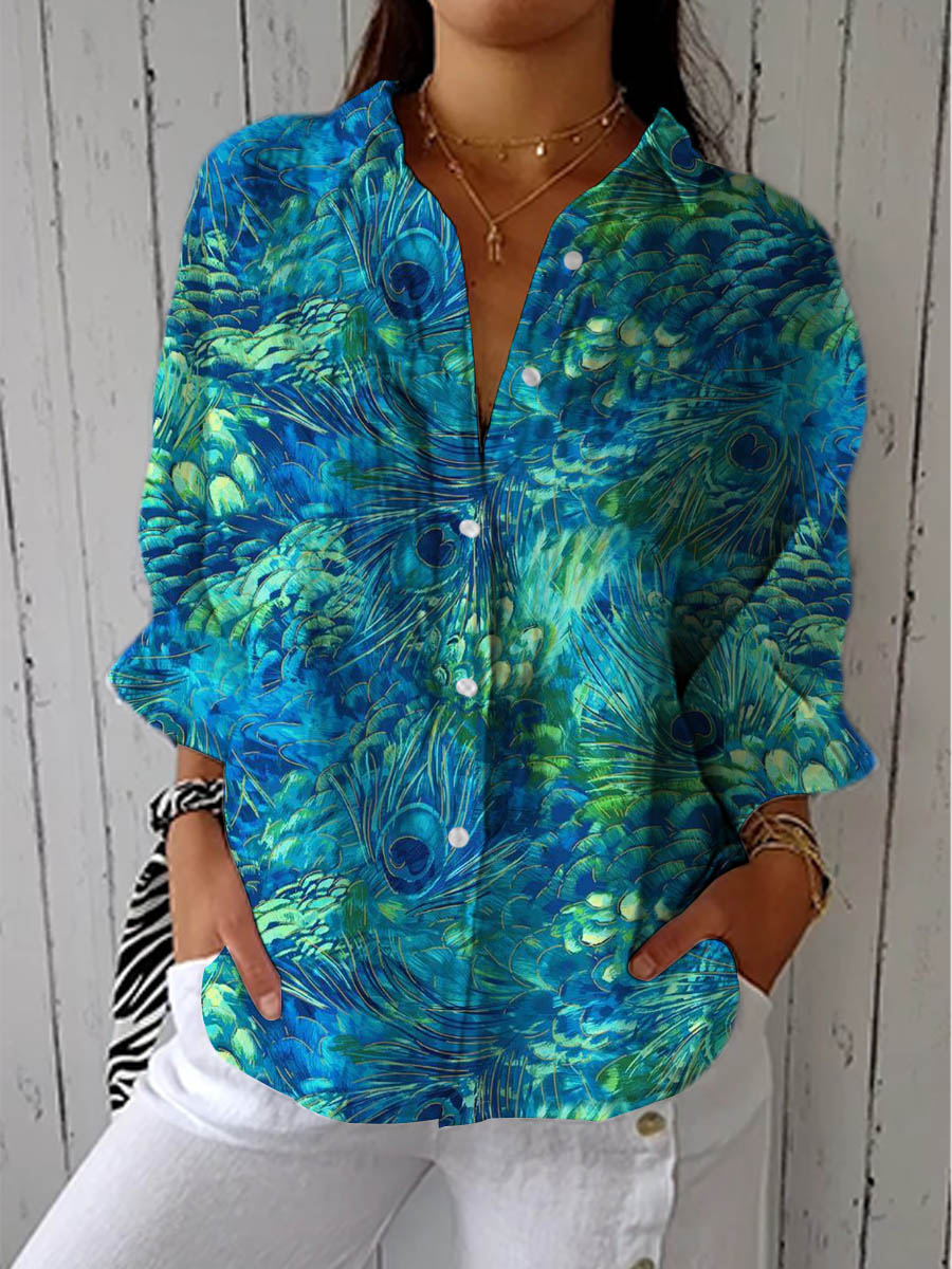 Elegant women's blouse with vibrant peacock design. Flowing fit for a stylish, casual chic look.