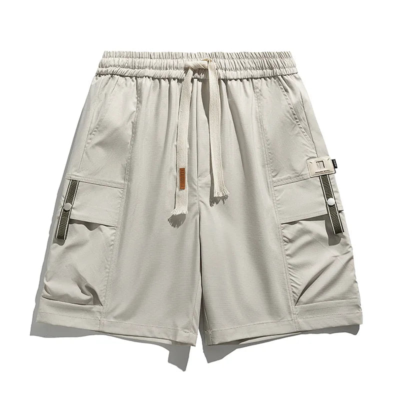 Beige men's spring cargo shorts with drawstring waist, utility pockets, perfect for casual summer comfort.