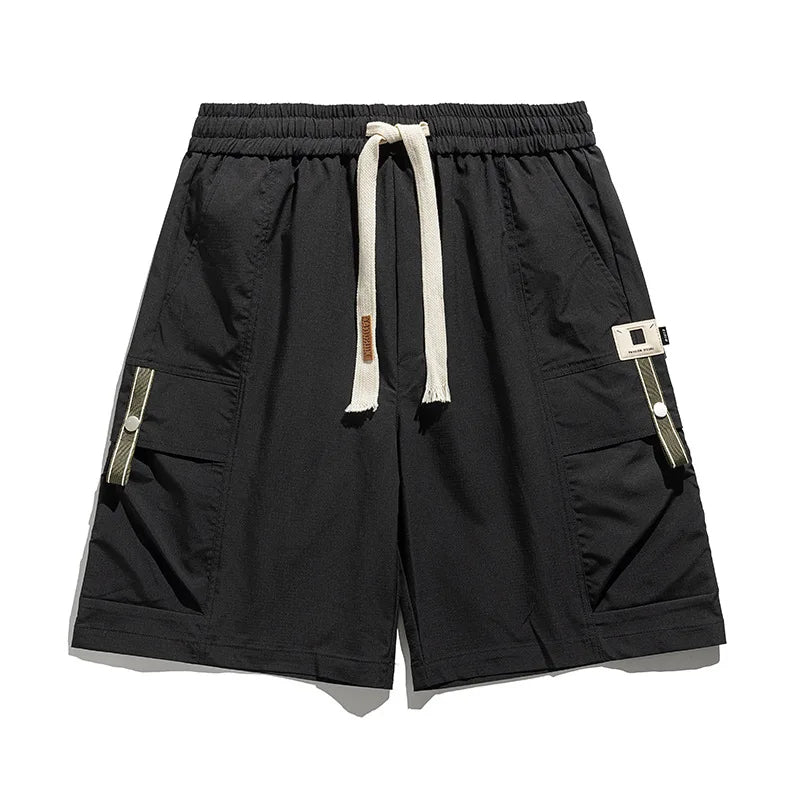 Black men's cargo shorts, relaxed fit with drawstring waist & multiple utility pockets for casual spring fashion.