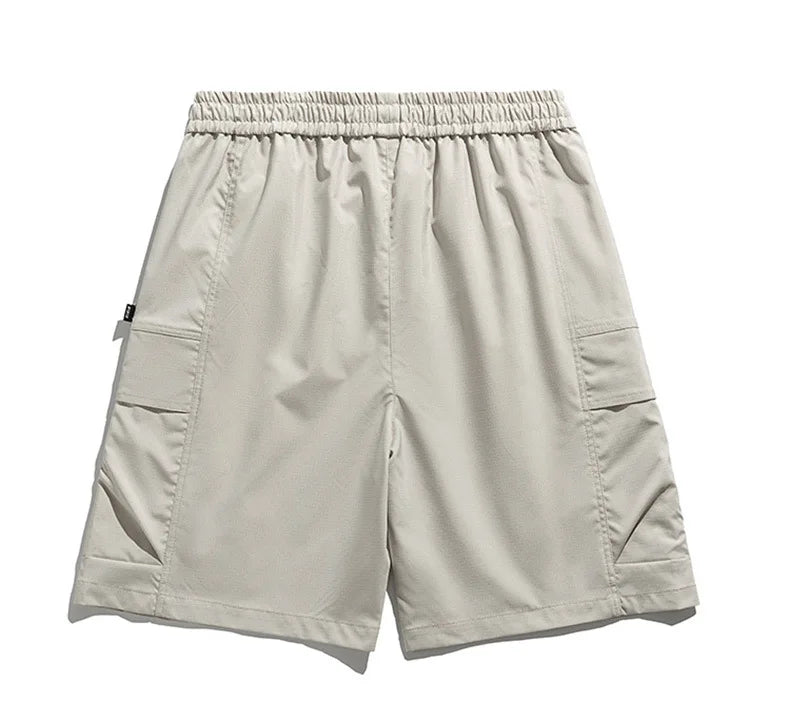 Stylish beige men's cargo shorts with drawstring waist, utility pockets, ideal for casual spring and summer wear.