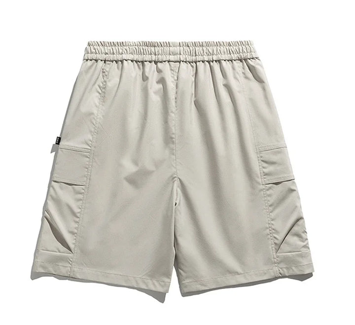Stylish beige men's cargo shorts with drawstring waist, utility pockets, ideal for casual spring and summer wear.