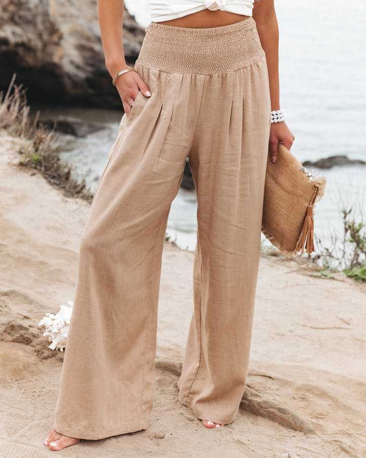 Women's flowy wide leg beach pants in a light fabric, perfect for stylish summer casual wear & resort outfits.