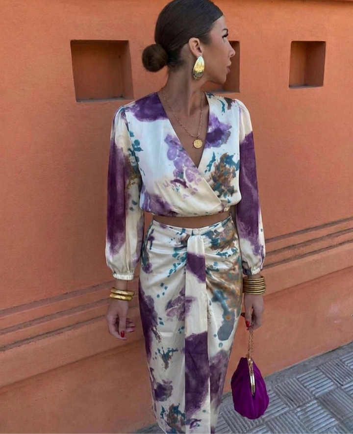 Versatile two-piece women's elegant summer outfit: v-neck blouse & flowing floral midi skirt.