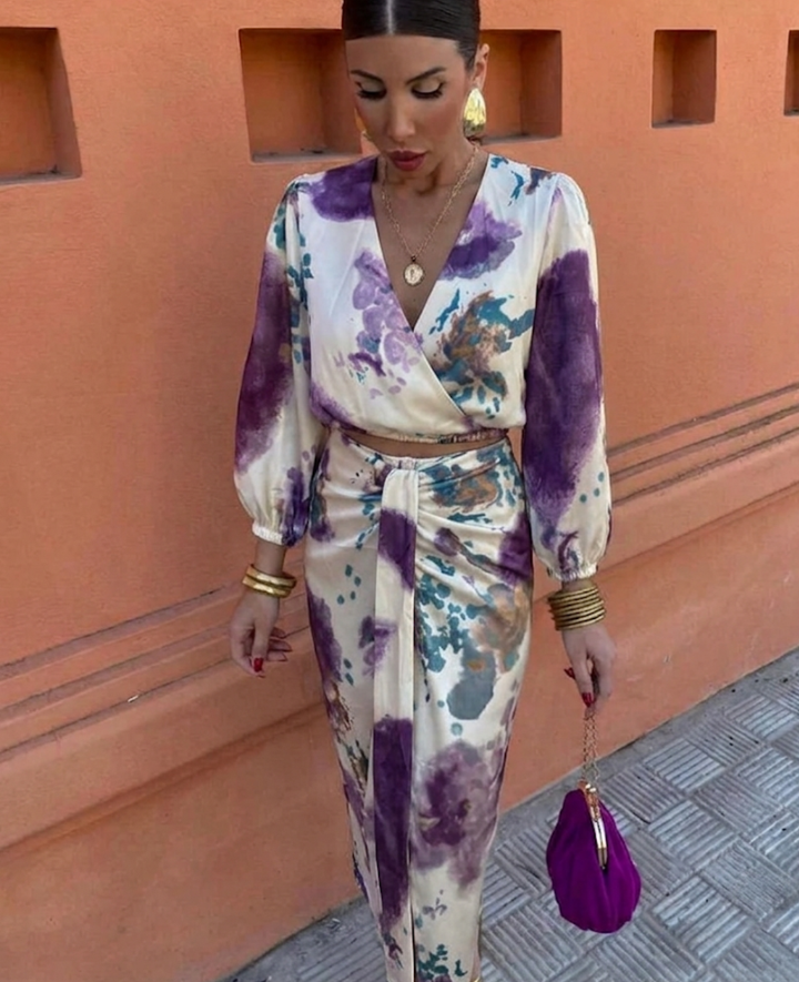 Stylish women's summer set featuring a floral print blouse and elegant midi skirt. Perfect for warm days.