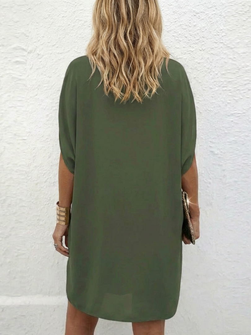 Elegant women's V-neck shift dress, draped fabric and cap sleeves offer a relaxed, stylish fit for travel.