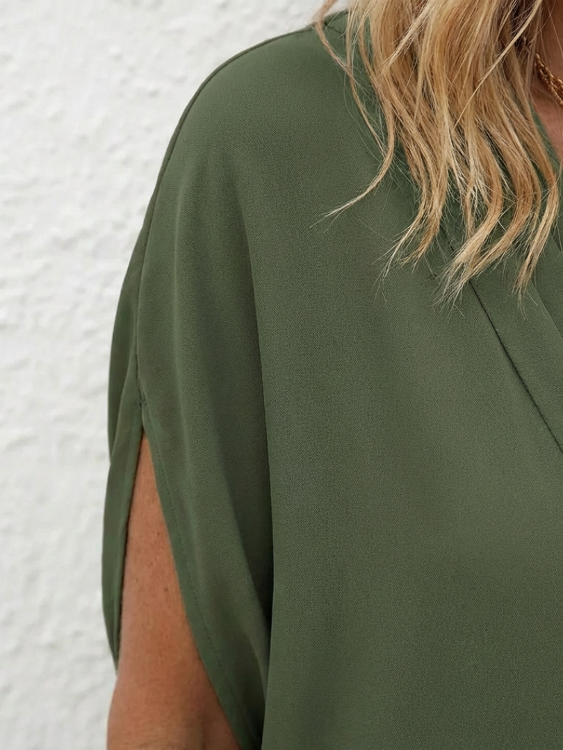 Comfortable women's shift dress, featuring a flattering draped V-neckline. Ideal for casual summer wear.