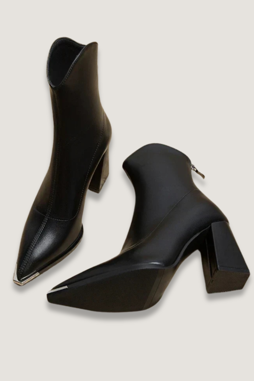 Women's chic black ankle boots with elegant chrome tip, perfect for versatile fashion and style.