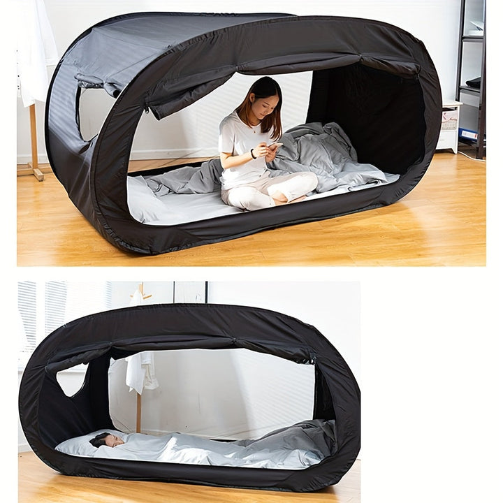 Black CozyNest folding tent bed for private camping sleep. Portable, ideal for indoor/outdoor use & student housing.