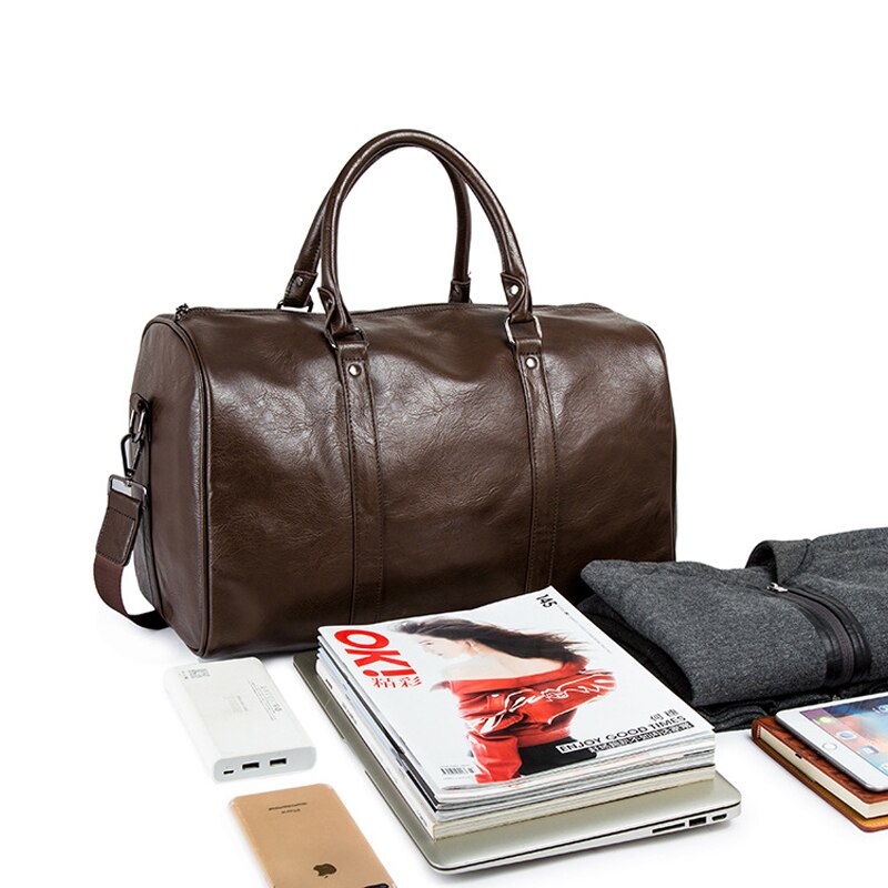 Unisex black duffel bag with front pocket. High-quality leather-look material.