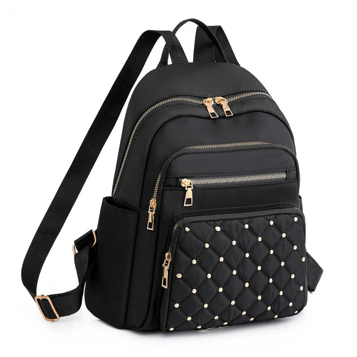 Black lightweight water-resistant nylon backpack for women, ideal for travel, school, or daily commute.