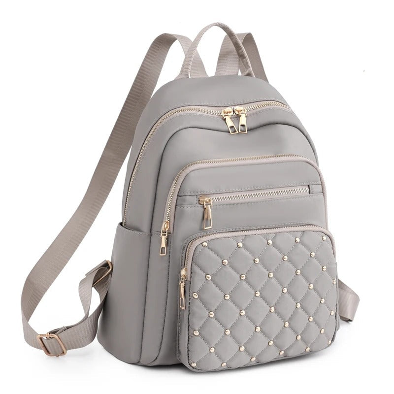 Durable women's nylon backpack with water-resistant finish, lightweight design for comfortable travel & school.