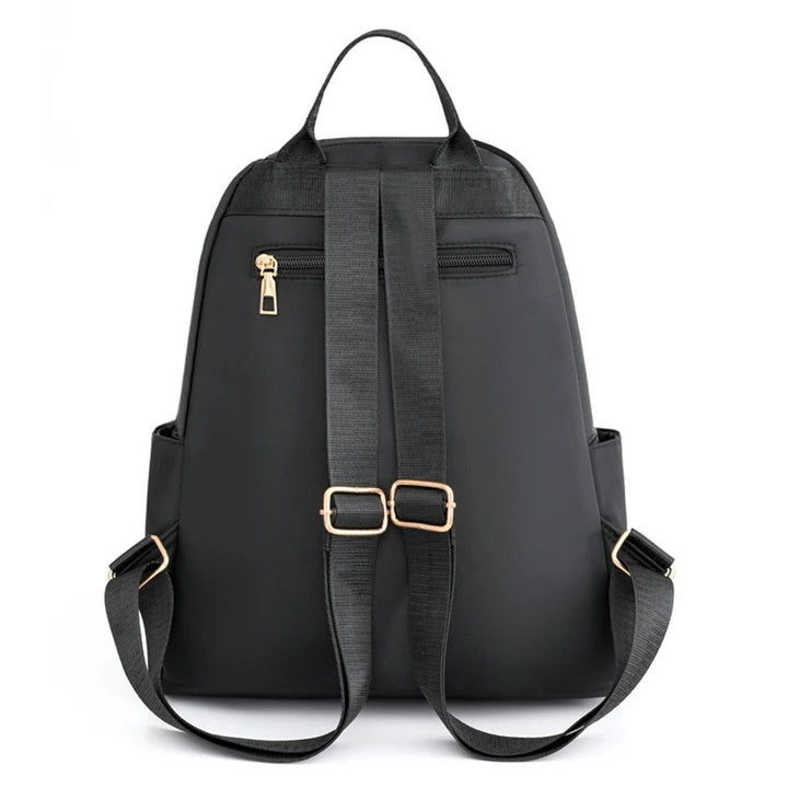 Comfortable, lightweight women's backpack in water-resistant nylon, versatile for travel, school, daily use.