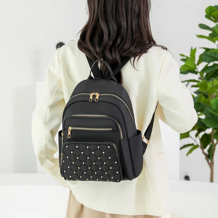 Khaki lightweight water-resistant women's nylon backpack, perfect for school, travel, or daily commute.