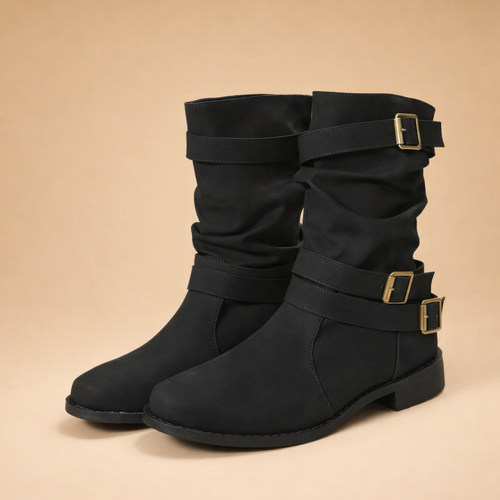 Women's stylish mid-calf boots with buckle straps. Chic, comfortable winter footwear for a fashionable look.