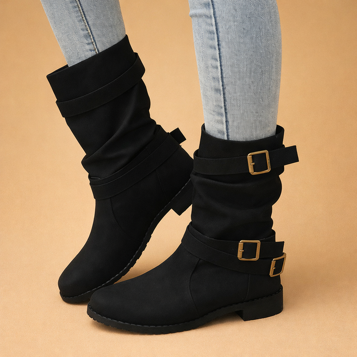 Chic women's mid-calf boots with buckle straps. Stylish winter fashion footwear for elegant versatile looks.