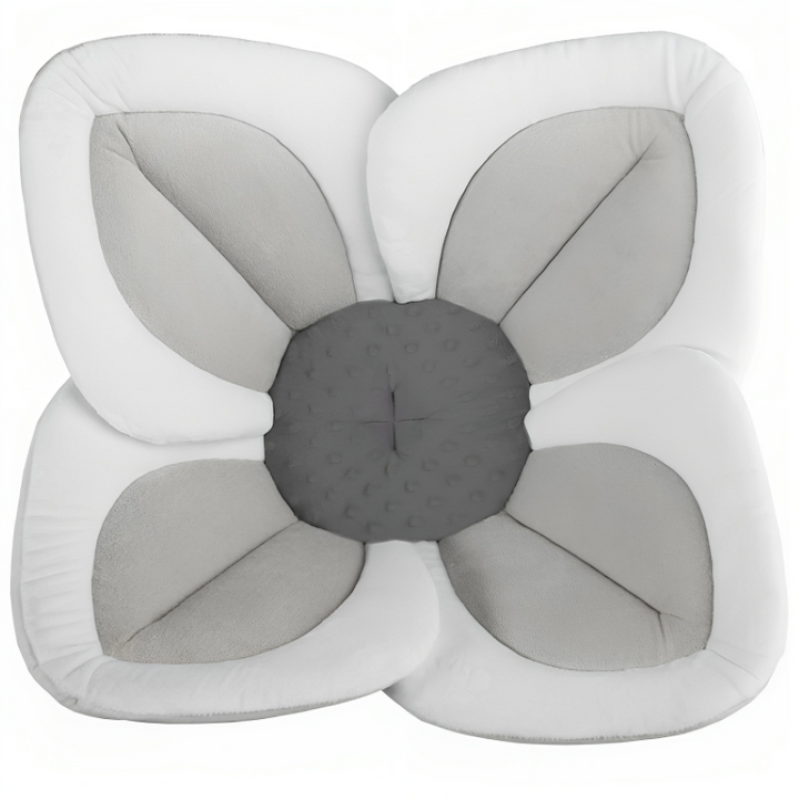 Soft blooming baby bath seat for sink, machine washable plush flower offers safe infant bathing.