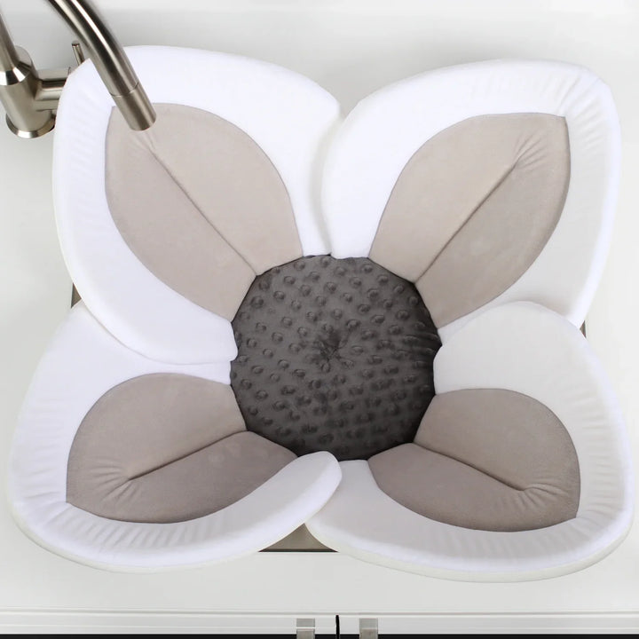 Travel-friendly blooming baby bath seat, soft plush flower support for safe & comfy infant bathing.